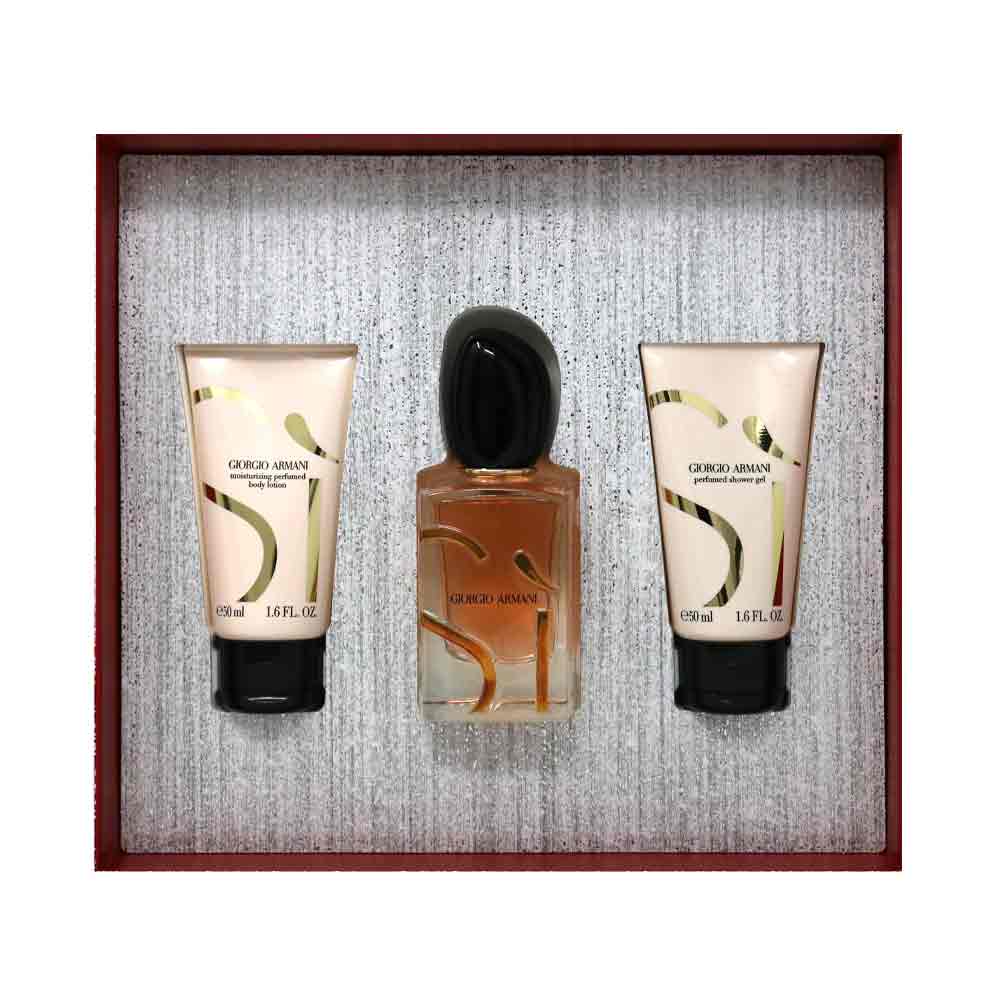 Giorgio Armani Si perfume gift set featuring a central 100ml bottle of Eau de Parfum with a black cap, flanked by two 50ml tubes of body lotion and shower gel, all in a textured gray box with a dark reddish-brown border.